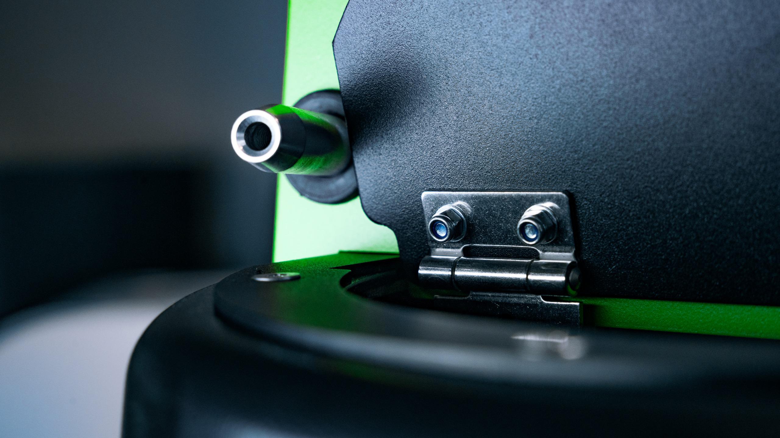 Precision-machined lid hinge and nozzle outlet detail
